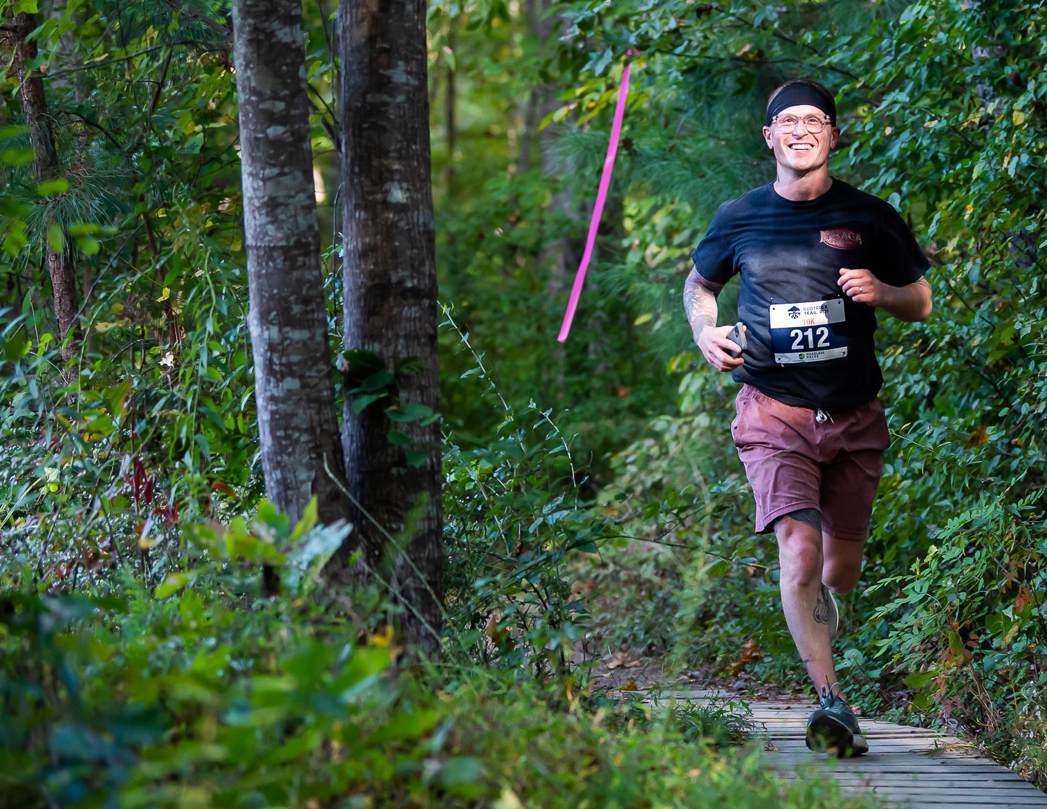 man in black shirt running on a trail